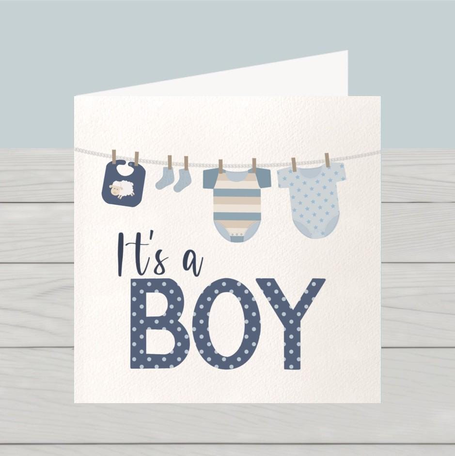 Newborn baby boy card: Congratulations baby boy card, blue baby clothes on washing line